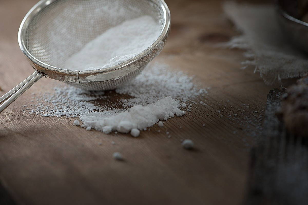 Icing Sugar and Sieve on wooden table
